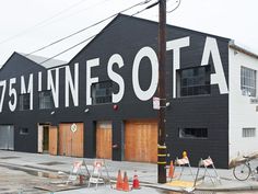 an industrial building that has been painted black and white with the word minnesota written on it