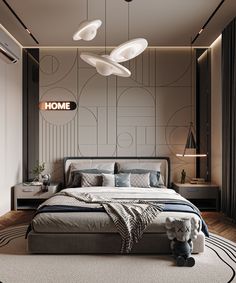 a bedroom with a large bed and two lamps hanging from the ceiling over it's headboard