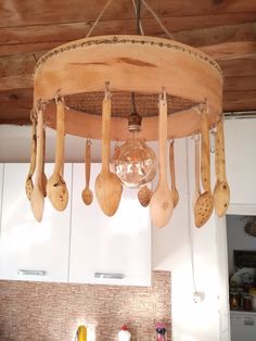 a chandelier made out of wooden spoons hanging from the ceiling