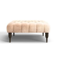 the foot stool is made from wood and has a beige upholstered fabric on it