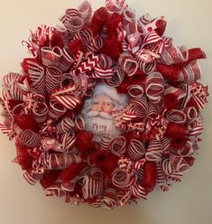 a red and white christmas wreath with a photo on it