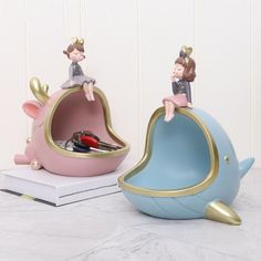 two ceramic figurines sitting on top of each other