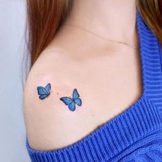 two blue butterflies on the shoulder