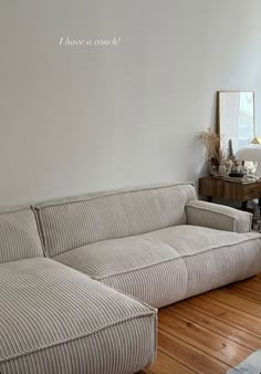 a couch sitting on top of a hard wood floor