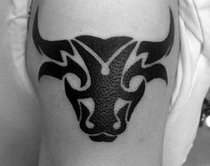 a man with a bulls tattoo on his arm