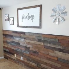 a wood paneled wall with a windmill sign above it and pictures on the wall