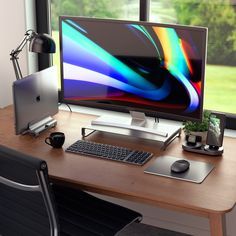 a computer monitor sitting on top of a wooden desk next to a keyboard and mouse