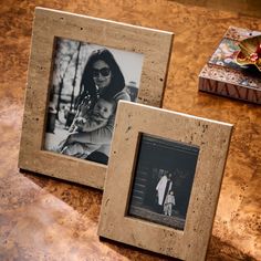 two frames sitting on top of a wooden table