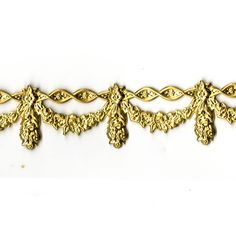 a gold bracelet with filigrees and leaves on the side, against a white background