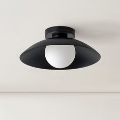 a black and white light hanging from the ceiling