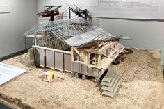 a model of a house on display in a museum