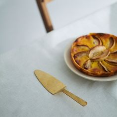 a pastry on a plate next to a spatula