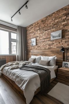 a bedroom with brick walls and wooden floors