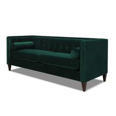 a green velvet sofa with wooden legs