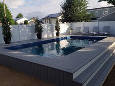 an empty swimming pool in the middle of a backyard