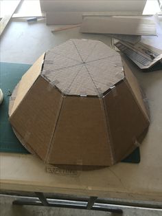 a large cardboard box sitting on top of a table next to a pair of scissors