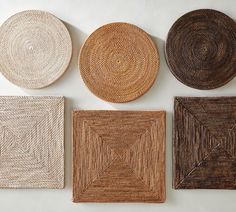 four woven coasters are arranged on a white surface, one is brown and the other is beige