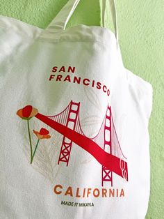 Take a piece of the Bay Area with you wherever you go with our San Francisco Tote Bag. With its spacious design and durable material, this bag is perfect for carrying all your essentials while exploring the city. Show off your love for San Francisco in style! Tote Bags are perfect for carrying around your everyday items while saving the planet one use at a time! Pair with your favorite pins or keychains for full customization. 18.5x15x4.7 inches 100% Cotton Canvas Double-sided Design Bag Care:To White Urban Everyday Bag, Urban Everyday White Bag, Everyday Urban White Bag, Casual Reusable Canvas Bag For Travel, Casual Reusable Bags For On-the-go, White Urban Bag For Everyday Use, White Reusable Travel Bags, White Tote Shoulder Bag For Weekend Trips, Reusable Tote Shoulder Bag For Travel