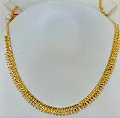 Indian designer choker necklace , 916 Yellow Gold GOLD PURITY : pure 22k / 916 gold purity Appx Weight: 12.50 grams Length : adjustable upto 18 inches Length Colour : YELLOW GOLD Hallmark: Hallmarked 916 stamp Hook: '' fish hook Design :Beautiful choker Bombay necklace indian style pendant necklace set. Design will be similar to listings designs pictures depending on stocks availability. Authentic 916 Gold FAQs Q: Is it real gold? A: yes it's real authentic genuine 916 gold Q: can pawn? A: yes it's pawnable ⭐️GoForGenuineGold⭐️ Pure Gold Necklace Indian, 22k Gold Necklace, Indian Choker Necklace, Gold Sunburst, Gold Necklace Indian, Beautiful Chokers, Choker Designs, Gold Necklace Simple, Necklace Indian