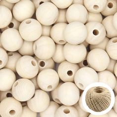 several white wooden beads with holes in the middle and a ball of yarn between them