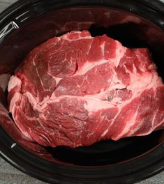 raw meat is in the slow cooker ready to be put into the crock pot