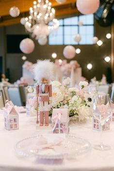 the table is set with pink and white decorations