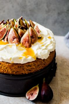 a cake topped with whipped cream and figs