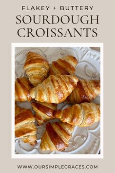 some croissants on a plate with the words flakey and buttery sourdough croissants