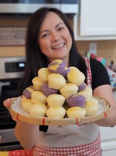 a woman holding a plate full of cookies