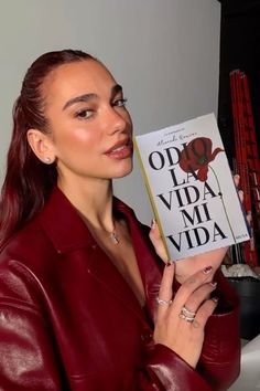 a woman holding up a book in front of her face