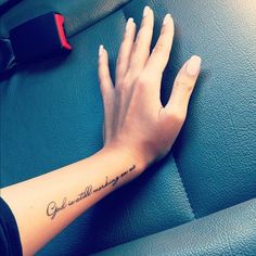 a person's hand with a small tattoo on their left wrist that says, god is everything you need