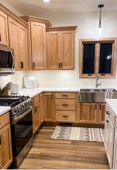 a kitchen with wooden cabinets and stainless steel appliances