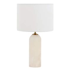 a table lamp with a white shade on the base and a light bulb in front of it