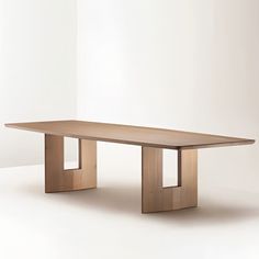 a wooden table sitting on top of a white floor covered in light colored wood planks