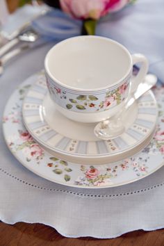 an empty cup and saucer on a table