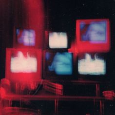 several televisions are shown with red and blue lights