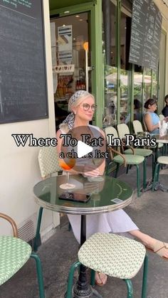 a woman sitting at a table in front of a restaurant with the caption where to eat in paris