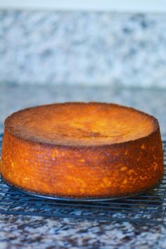 a round cake sitting on top of a cooling rack