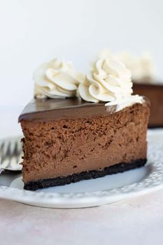 a slice of chocolate cheesecake with whipped cream on top