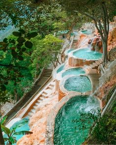 an outdoor swimming pool surrounded by trees