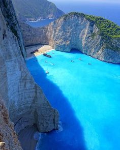 an aerial view of the blue water and cliffs