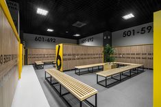 an empty room with benches and lockers in it