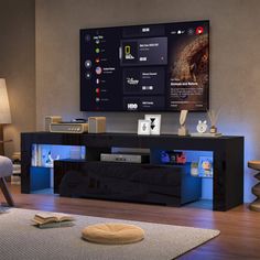 a living room with a large flat screen tv mounted on the wall above it's entertainment center