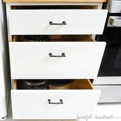 the drawers are open to show pots and pans