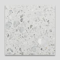 a white tile with small pieces of glass on it