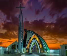 an artistic photo of a church at sunset