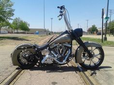 a silver motorcycle parked on the side of a road