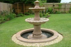 a water fountain in the middle of a garden