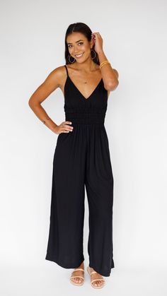 Stand out in this stunning jumpsuit, made to flow with buttery soft rayon and an exaggerated wide pant leg. Features adjustable straps and a gentle smocked waist to flatter. ** Our Model is 5'8" and wearing a size SMALL. ** Fabric & Care Instructions:100% RayonHand wash cold Line dry Sleeveless Jumpsuits And Rompers With Smocked Back For Brunch, Chic Maxi Length Jumpsuits And Rompers With Elastic Waistband, Chic Jumpsuit With Smocked Bodice For Day Out, Black Maxi Jumpsuits For Vacation, Chic Flowy Jumpsuits And Rompers For Brunch, Flowy Casual Jumpsuits And Rompers For Brunch, Black Maxi Length Casual Jumpsuits And Rompers, Chic Flowy Jumpsuits For Brunch, Casual Flowy Jumpsuits And Rompers For Brunch