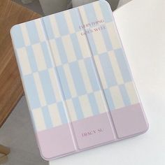 a pink and blue case sitting on top of a white table